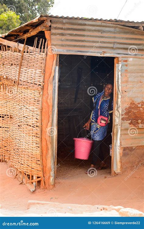 unidentified local woman carries a bucket in a village in guine editorial stock image image of