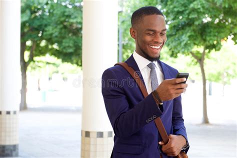 Happy Young Businessman Reading Text Message On His Mobile Phone Stock
