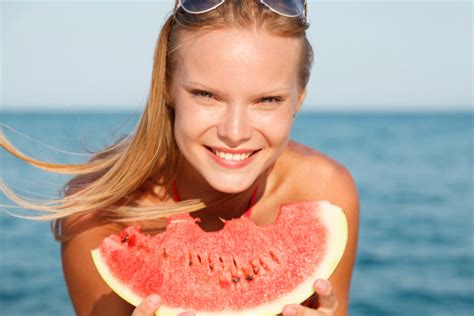 Happy Young Woman Eating Watermelon At Summer Beach Stock Photo