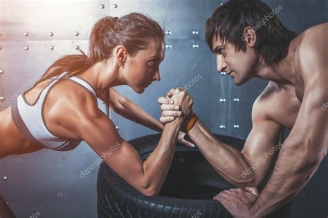 Athlete Muscular Sportsmen Man And Woman With Hands Clasped Arm