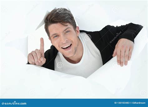 Businessman Bursting Through A Paper Wall And Showing Up Stock Image