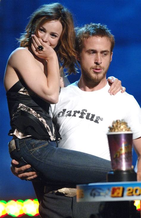 The Couple Is Hugging Each Other While Holding Popcorn