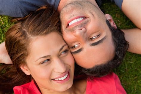 Premium Photo Close Up Two Friends Looking At Each Other While Lying