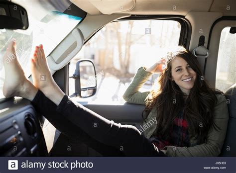 Portrait Confident Barefoot Brunette Woman With Feet Up On Dashboard In