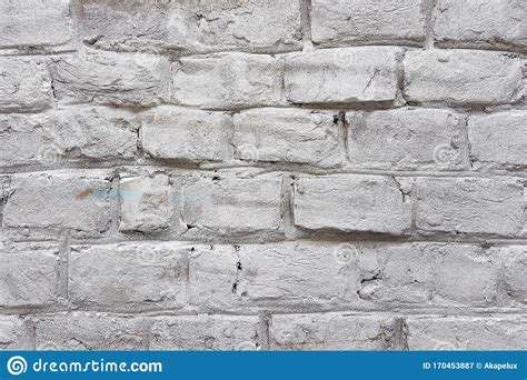Old White Brick Wall With Damaged White Paint Layer Closeup Background