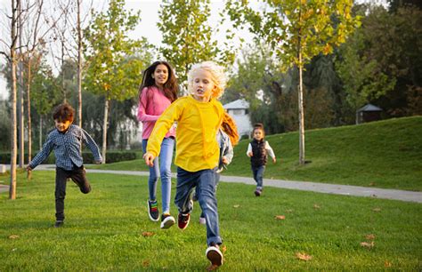 Grupo Interracial De Niños Niñas Y Niños Jugando Juntos En El Parque En El Día De Verano Foto De