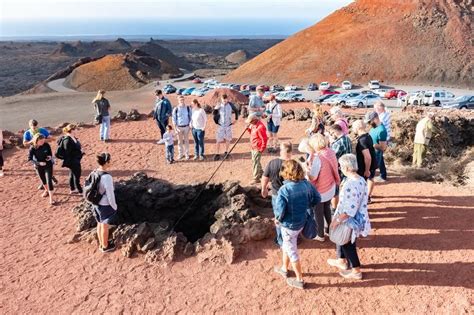 There are three interesting possibilities to experience. LANZAROTE, SPAIN - DEC 13, 2018: Tourist Having Camel ...