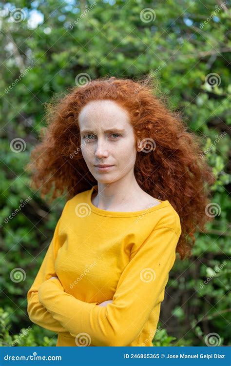 Lose Up Portrait Of A Red Hair Woman Girl With Freckles Looking At
