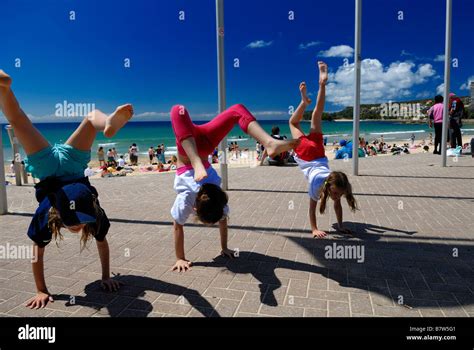 Three Children Two 10 Year Olds One 6 Year Old Doing Handstands On