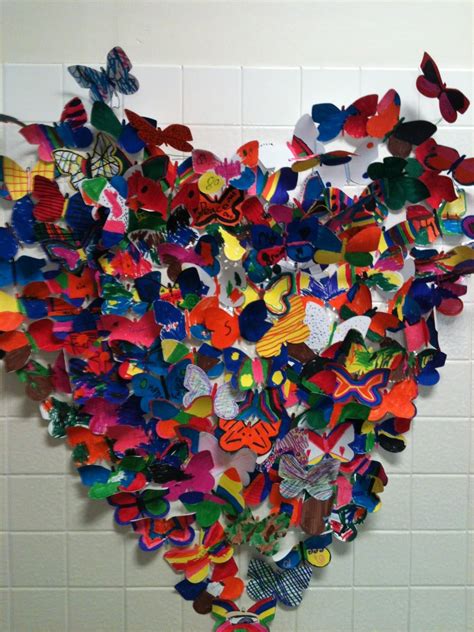 There Is A Heart Made Out Of Many Different Colored Pieces Of Paper On