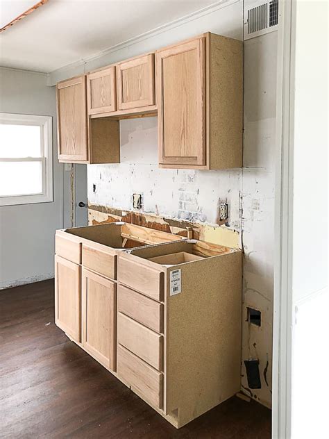 Most cabinet types, including metal, plastic laminate, painted wood, and vinyl cabinets, can be cleaned with a solution of liquid dish soap and warm water. Unfinished Wood Cabinets To Make The Flip House Kitchen ...