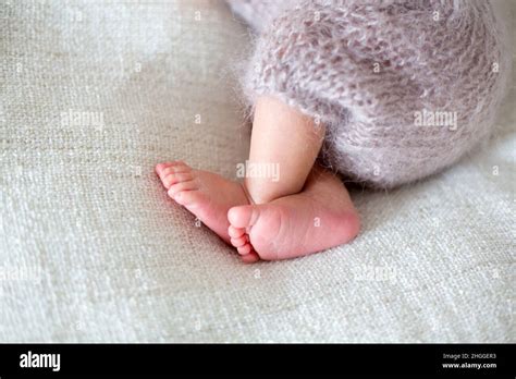 Newborn Baby Boy Sleeping Peacefully Wrapped In Knitted Wrap Stock