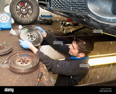 Mechanic Checking Disc Of Wheel Underneath Car Stock Photo Alamy