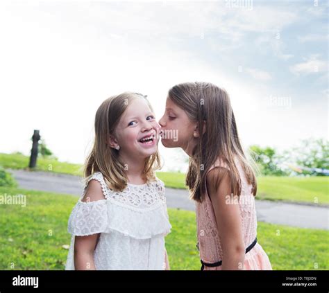 Little Girls Sisters Kissing Stock Photo Alamy