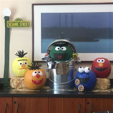 The Sesame Street Characters Are Painted On Pumpkins And Placed In