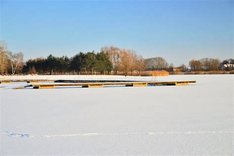 A Frozen Lake And Pier On A Frosty Sunny Winter Day Stock Photo