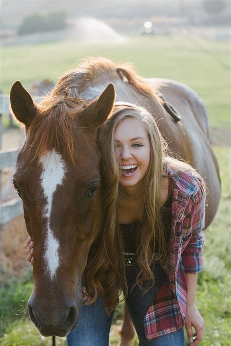 Smiling Teen Girl Standing By Horse In Pasture By Stocksy Contributor