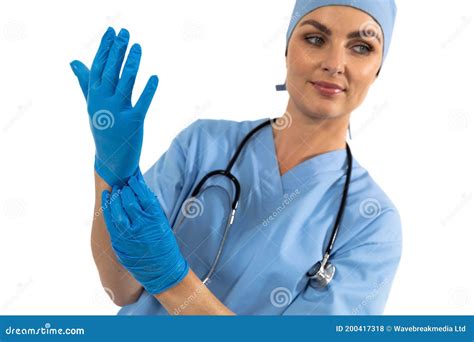 Female Surgeon Wearing Protective Gloves Against White Background Stock