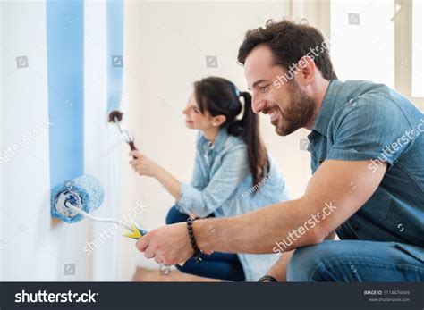 Young Couple Painting Walls Their New Stock Photo 1114474949 Shutterstock