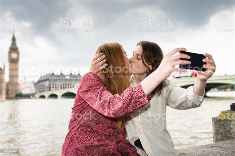 Lesbian Couple Take A Selfie In London On Westminster Bridge Stock