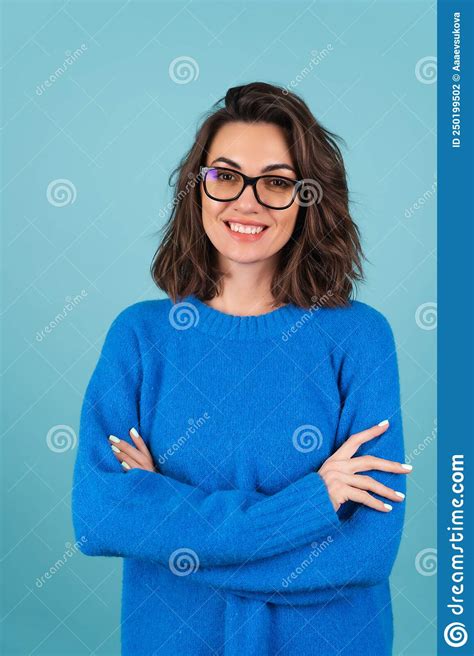 A Woman In A Blue Knitted Sweater And Natural Make Up Curly Short Hair