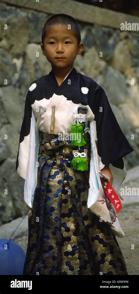 Young Boy In Japanese Traditional Dress Visiting Shrines Of Nara Japan