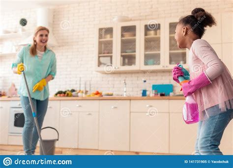 Cute Curly Daughter Having Much Fun Helping Her Mom With Cleaning Stock Image Cartoondealer
