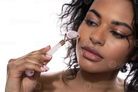 Beautiful Black Woman With A Smooth Skin Using Rose Quartz Derma Roller