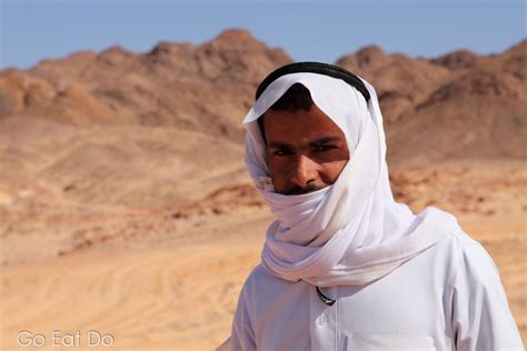 bedouin guide in a keffiyeh and jalabiya traditional arabic clothing at the coloured canyon in