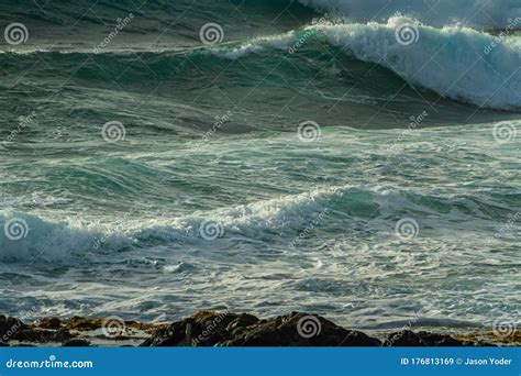 Rough Blue Ocean Surf Crashing Into A Rocky Coastline Stock Image