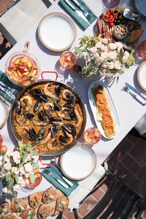 A great opportunity to include your guests in the meal preparation and combine the aperitif course. Paella & Sangria: A Late-Summer Dinner Party (With images ...
