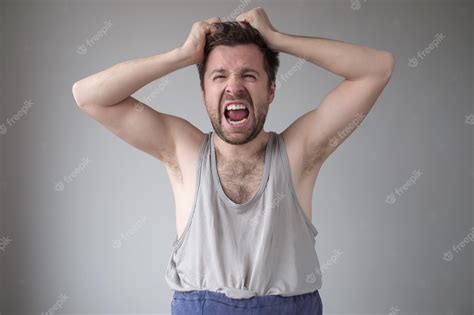 Premium Photo Untidy Young Man Screaming And Pulling His Hair