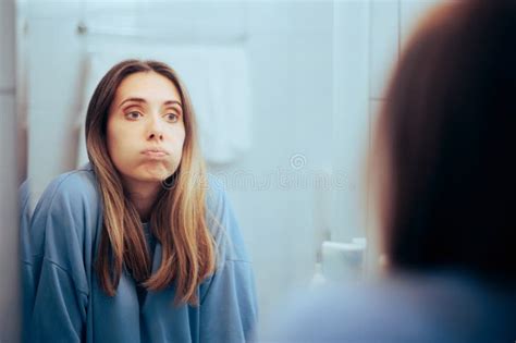 Unhappy Woman Looking In The Mirror Feeling Overwhelmed Stock Photo