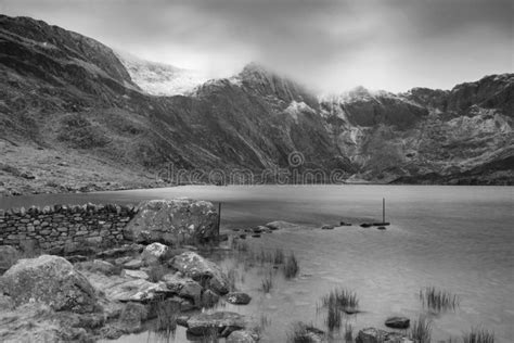 Beautiful Moody Winter Landscape Image Of Llyn Idwal And Snowcapped