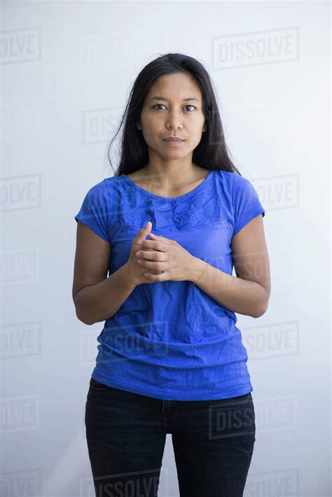 Woman Standing With Clasped Hands Portrait Stock Photo Dissolve