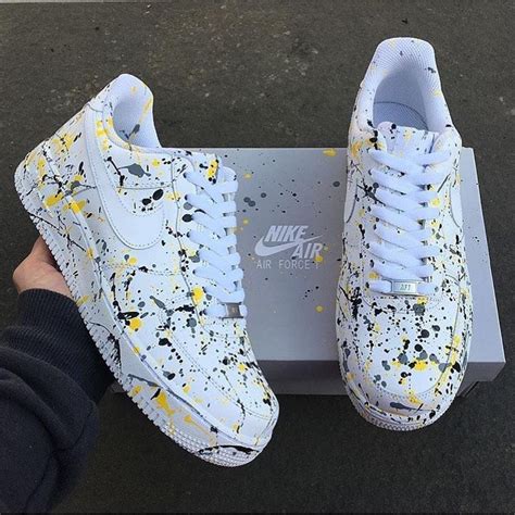 The Pair Of Sneakers Nikes Customized Air Force 1 Paint Splash On The