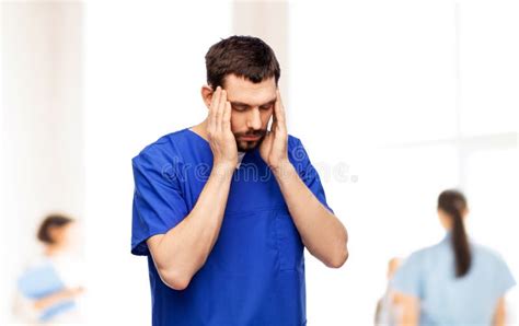 Stressed Doctor Or Male Nurse In Blue Uniform Stock Photo Image Of