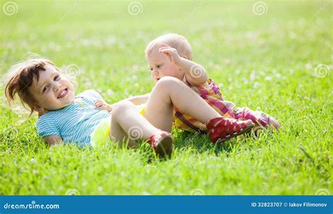 Happy Children Playing In Grass Royalty Free Stock Photography