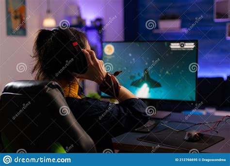 Focused Gamer Puts Professional Headphones And Playing Stock Image