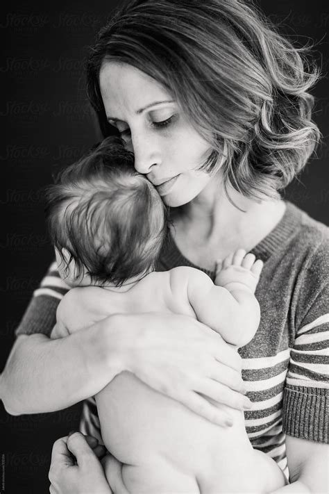 Black And White Portrait Of A Mother Bonding With Naked Newborn Son By Stocksy Contributor