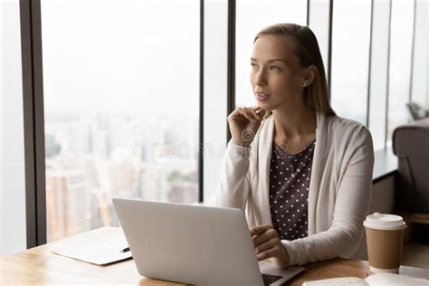 Thoughtful Businesswoman Pondering On Project At Workplace With Laptop Stock Image Image Of