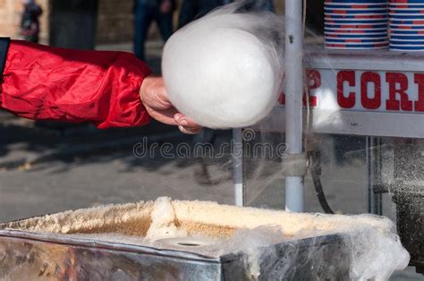 The Process Of Making Cotton Candy The Seller Winds A Stick Of Cotton