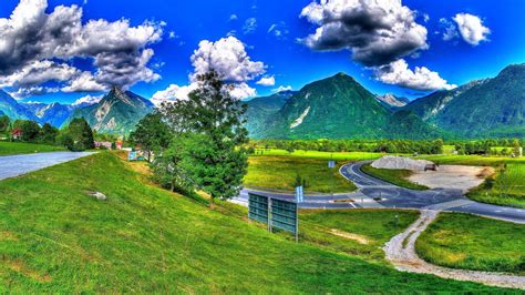 Landscape View Of Green Trees Covered Mountains Road Between Green