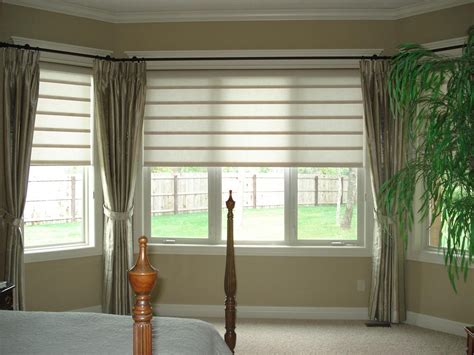 Lucca studio armchairs create a conversation space in the living room; Bay Window Blinds and Curtains | Curtain Ideas