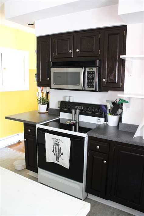 Oak kitchen with arched door style and strong stain colour in this next kitchen, the countertop and backsplash were reasonably updated but didn't work well with the strong red of the cabinets. How to refinish oak cabinets with stain (the big reveal ...