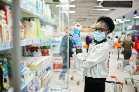African Woman Wearing Disposable Medical Mask And Gloves Shopping In Supermarket During