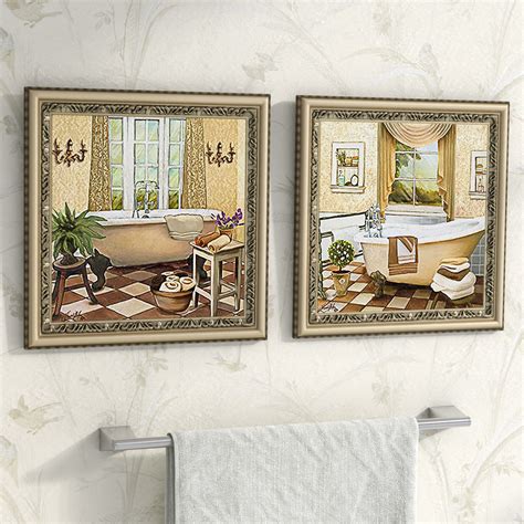 Two Framed Pictures Hanging On The Wall Above A Bathtub