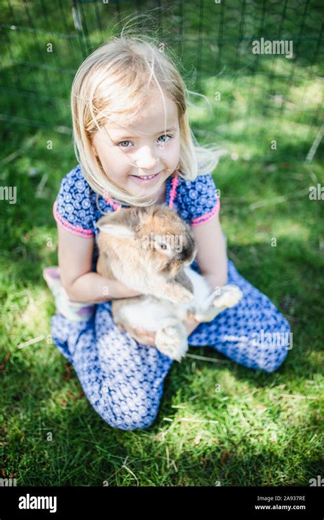 Girl Holding Rabbit Stock Photo Alamy