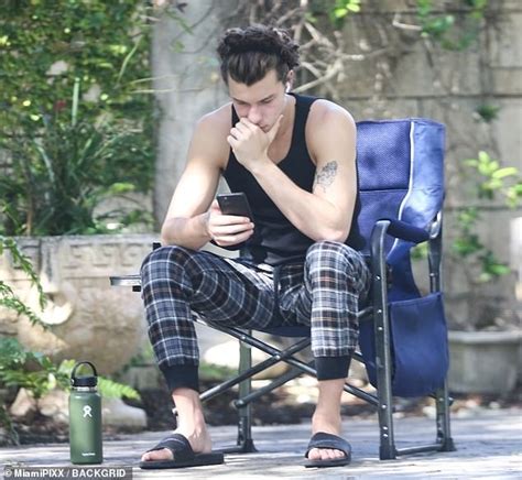 Shawn Mendes Shows Off His Muscles As He Sits Outside In A Tank Top And