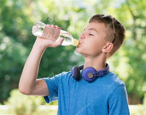 Teen Boy Drinking Water — Stock Photo © Valiza 114884958